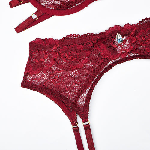 Detailed flat lay view of the waist-cinching high-waisted lace garter belt from the KissKismet crimson desire 4-piece set.