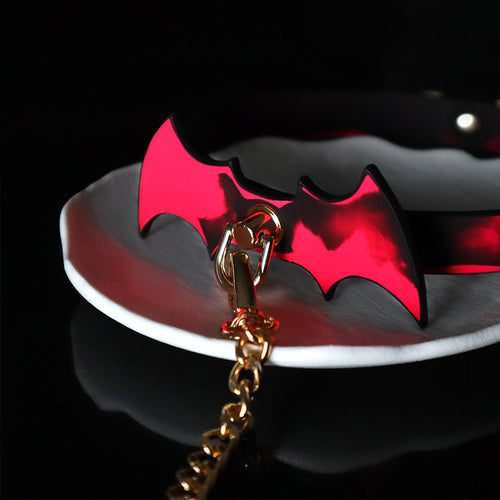 Close-up of the heat-activated red bat emblem and premium gold D-ring hardware.