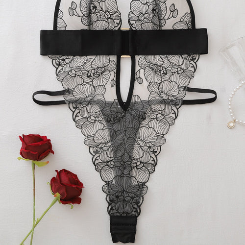 Close-up flat lay of the high-cut bottom and center cutout of the embroidered bodysuit.