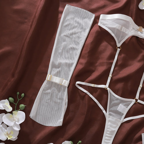 Flat lay presentation of the matching ivory sheer mesh arm sleeves and thigh-high stockings included in the KissKismet set.