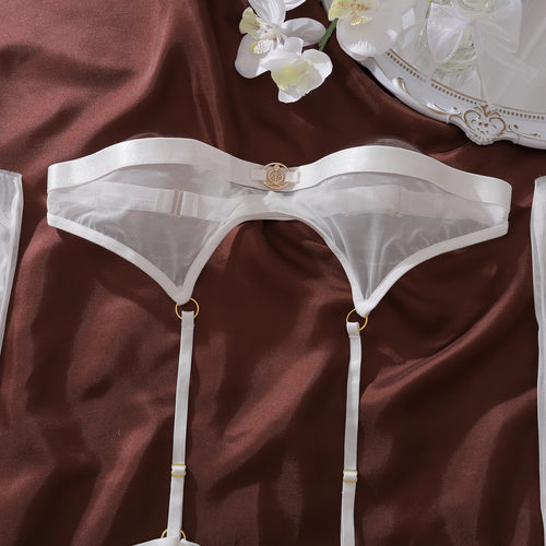 Close-up flat lay view of the KissKismet ivory sheer mesh strapless bandeau top, featuring delicate gold-tone hardware and clean lines.