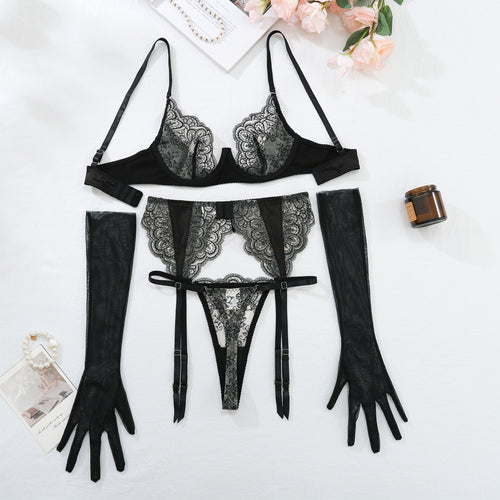 Flat lay presentation of the complete KissKismet 4-piece set, including the balconette bra, garter, thong, and sheer gloves.