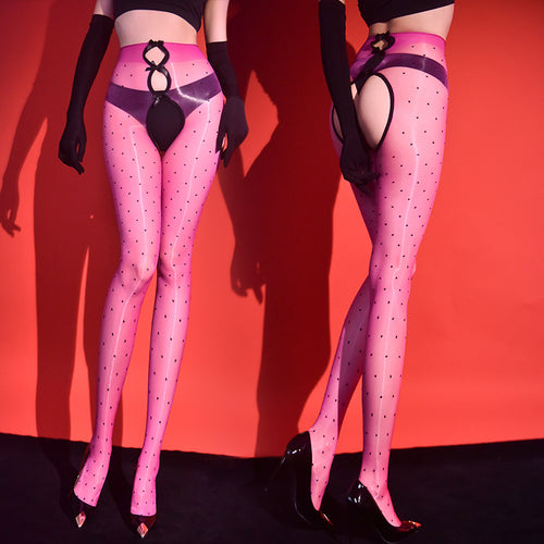 Editorial style boudoir shot of the KissKismet vibrant hot pink polka dot sheer tights, contrasting beautifully with sleek black opera gloves.
