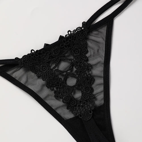 Close-up flat lay detail of the striking corset-style lace-up back design on the KissKismet noir sheer mesh thong.