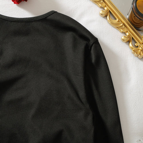 Close-up of rib-knit texture on long-sleeve bodysuit