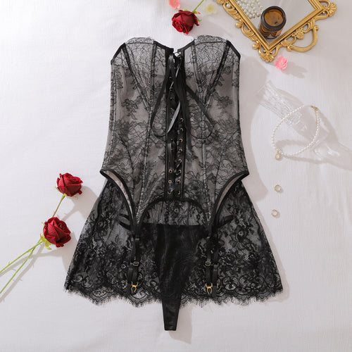 Full flat lay of sheer black lace corset, skirt, and garter set
