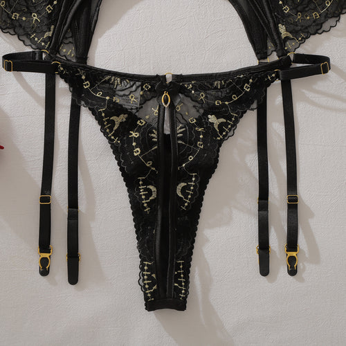 Detail of celestial-inspired gold thread embroidery on lace thong