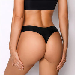 Front view of a model wearing KissKismet black seamless ice silk thong under high-waisted leggings.