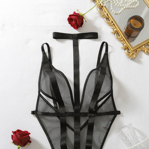 Detailed view of fishnet harness bodysuit flat lay