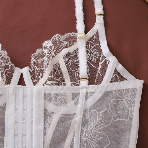 Detailed view of white corset back closure and straps