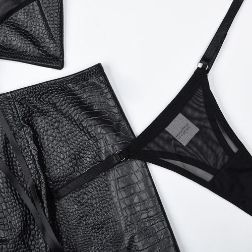 Close-up flat lay view of the skirt's daring side slit lacing detail and the included matching minimal black thong.
