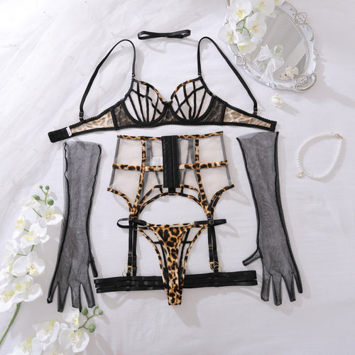 Flat lay view focusing on the matching leopard print geometric cage bra, high-waisted garter, and thong.