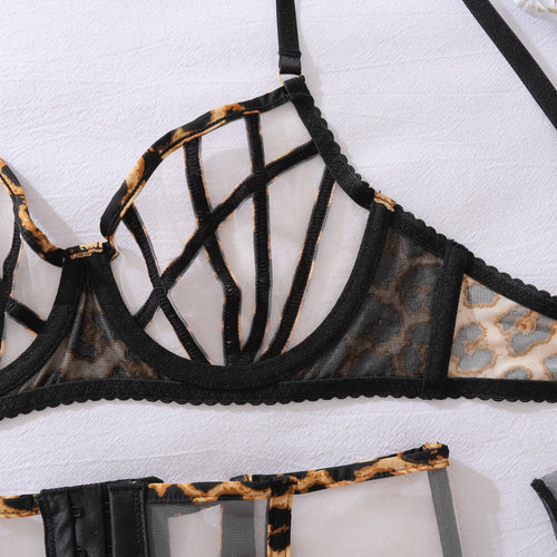 Detailed shot of the high-quality garter clips and the provocative strappy details of the leopard thong.