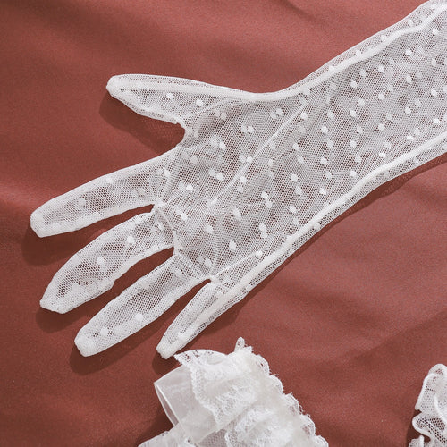 Detailed flat lay view of white dotted sheer mesh gloves