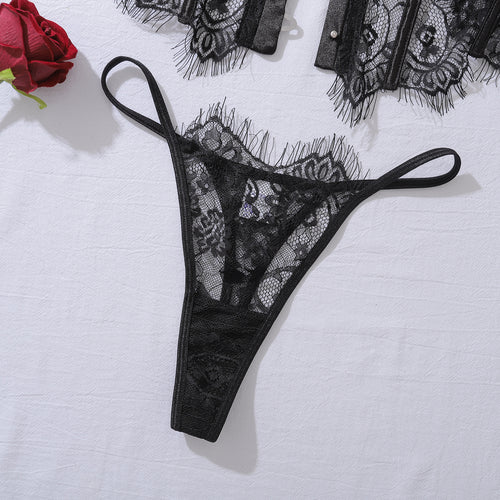 Flat lay view of the matching KissKismet black floral lace thong, highlighting the intricate pattern and soft scalloped edges.