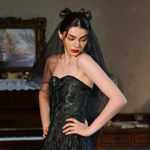 Angled front view highlighting the sheer volume and delicate wavy edges of the short black veil.