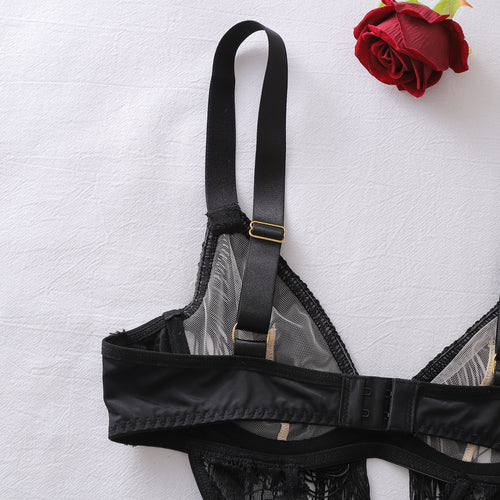 Detail of adjustable straps on black lace bodysuit