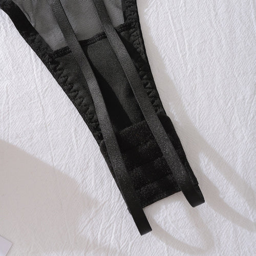 Close-up of bottom strap construction on mesh bodysuit