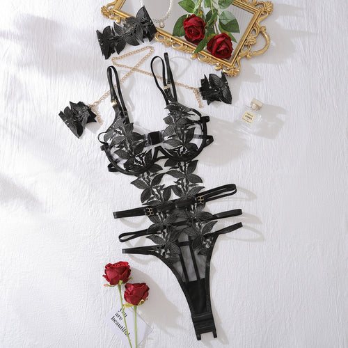 Flat lay of black floral embroidered bodysuit set