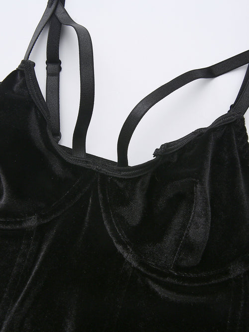 Close-up of the bustier cups and double strap details on a black velvet corset.