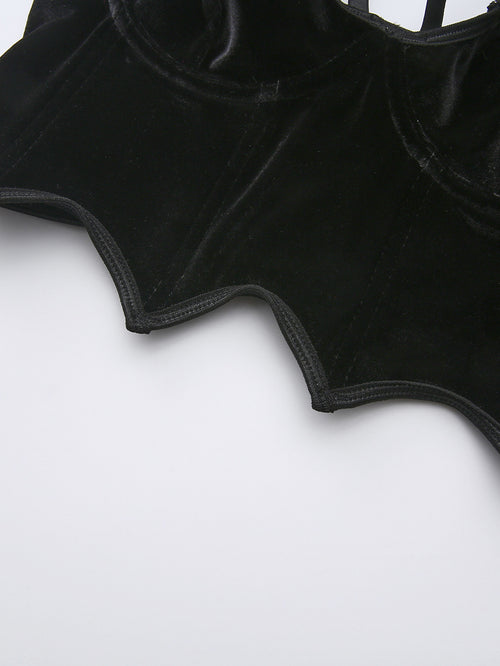 Close-up of the gothic jagged pointed hem on a black velvet corset top.