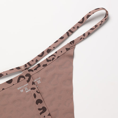Close-up flat lay detail of the minimal elastic side straps and classic leopard print pattern on the KissKismet thong.