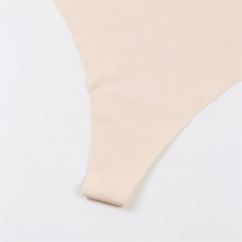 Detailed macro shot focusing on the durable seamless bonding of the nude thong's leg opening.