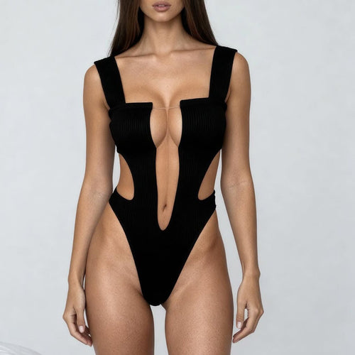 Full body view of black deep-plunge cutout bodysuit