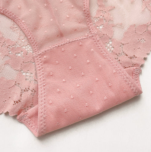 Close-up detail of the delicate dusty pink floral lace pattern and premium scalloped hem on the KissKismet underwear.