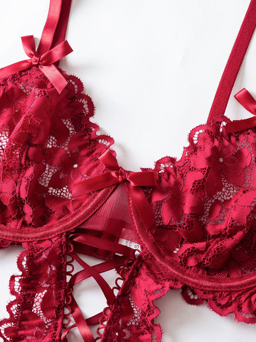 Close-up shot focusing on the intricate floral lace and supportive bust design of the crimson garter bodysuit.