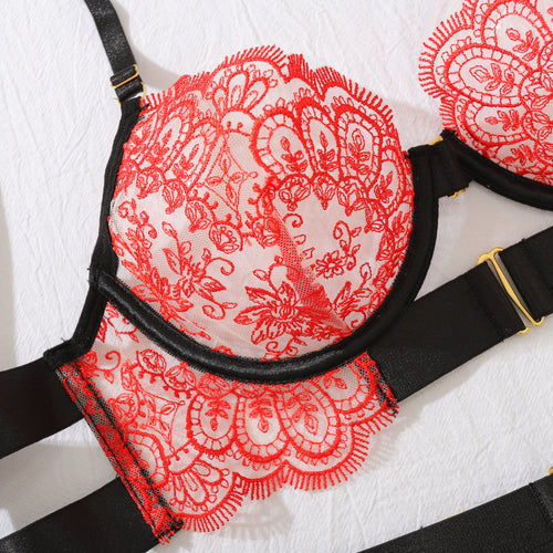 Close-up flat lay detail of the KissKismet red scalloped lace bra cups with contrasting bold black elastic strapping.