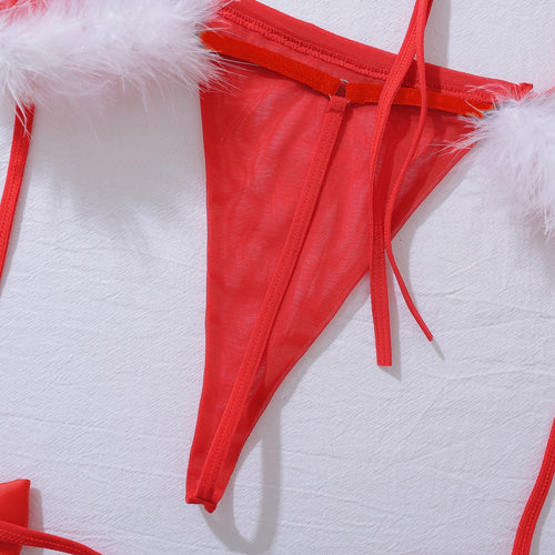 Macro detail flat lay of the red thong and soft white faux fur trim connection.