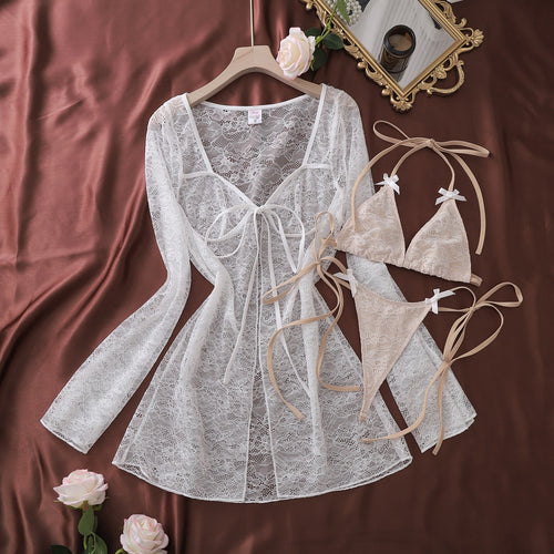 Flat lay of full white lace resort cover-up and lingerie set