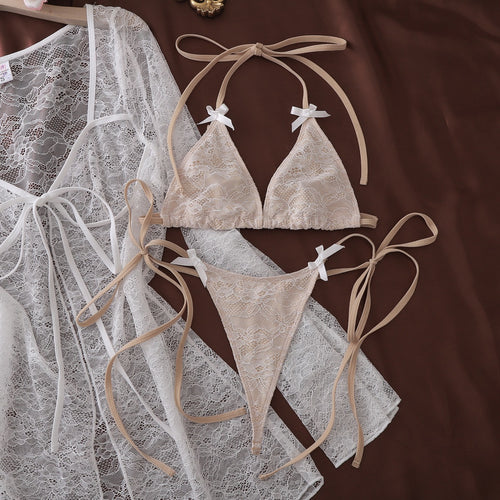 Flat lay of white lace cover-up and matching bikini set