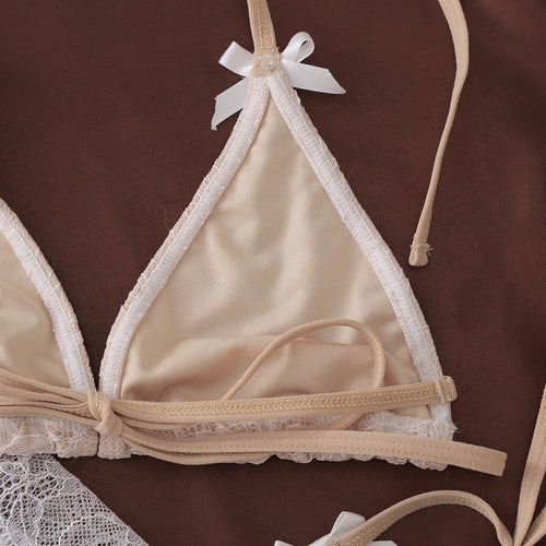 Detail of soft lining and bow accent on white lace bikini style lingerie