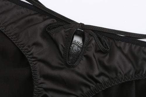Close-up of the front of the KissKismet satin thong panty, highlighting the intricate eyelash lace insert and elegant keyhole detail.