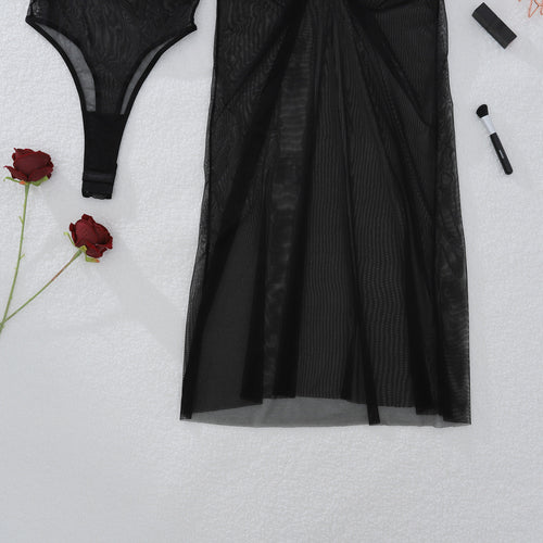Close-up flat lay detail of the KissKismet sheer black maxi skirt, highlighting the flattering ruched hip design.