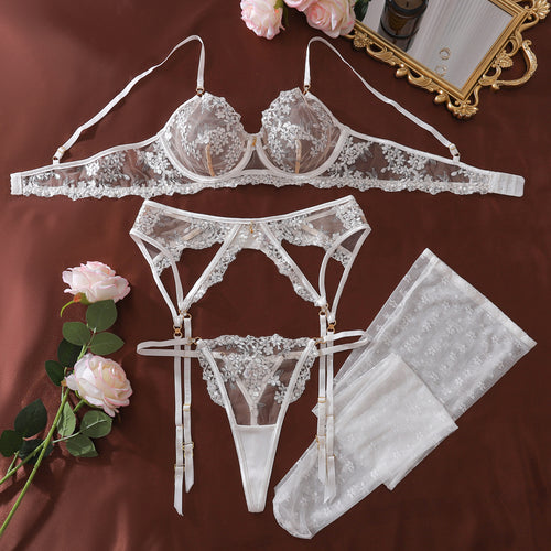 Flat lay view focusing on the elegant sheer white mesh and intricate floral embroidery of the underwire bra.