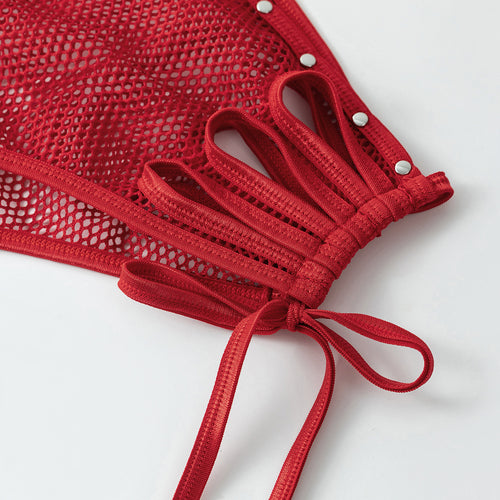 Close-up of the red metallic bikini bottom side featuring mesh panels, cutouts, and studded tie straps