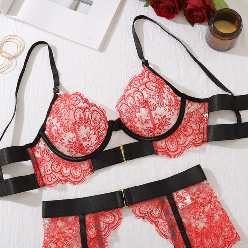 Back flat lay view of the KissKismet crimson lace bra, showcasing the striking black elastic strapping and daring cut-out back design.