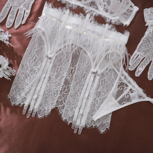 A detailed close-up illustrative flat lay of the sheer lace G-string and matching glove detail.