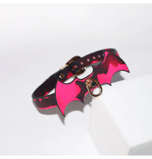 Angled view of the buckled heat-reactive leather collar resting on a white surface.