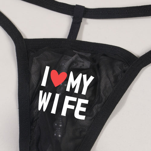 Back on-body view highlighting the minimalist single-string T-back design and erotic pearl detail of the men's thong.