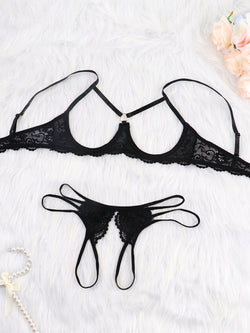 Flat lay of black open-cup bra and strappy thong set
