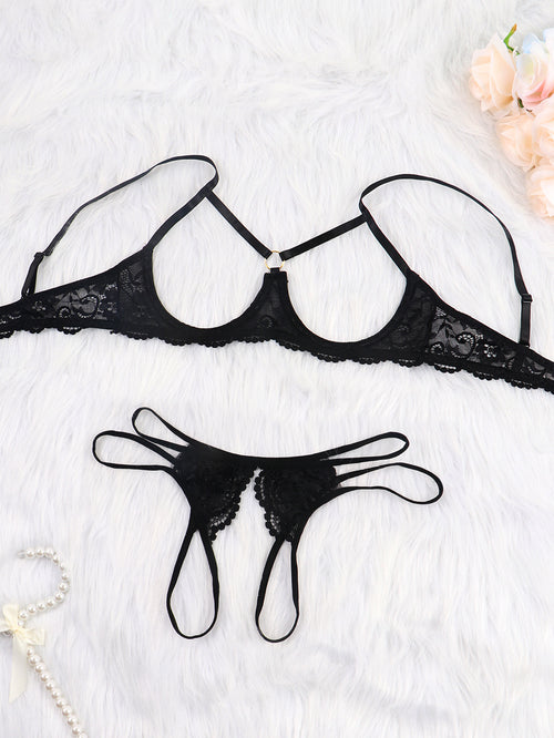 Flat lay of black open-cup bra and strappy thong set
