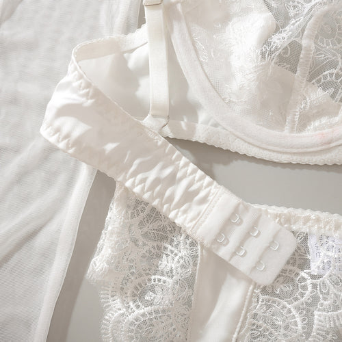 Close-up flat lay detail of the secure multi-row hook-and-eye back closure and adjustable straps on the KissKismet white lace bra.